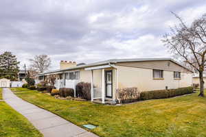 View of property exterior featuring a yard