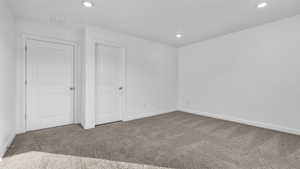 Unfurnished bedroom with carpet flooring