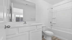 Full bathroom featuring vanity, hardwood / wood-style flooring, toilet, and shower / bathtub combination