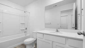 Full bathroom featuring shower / bathing tub combination, vanity, toilet, and hardwood / wood-style floors