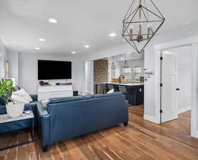 Living room with dark hardwood / wood-style flooring