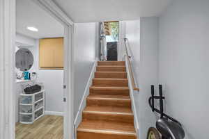 Stairway featuring hardwood / wood-style floors