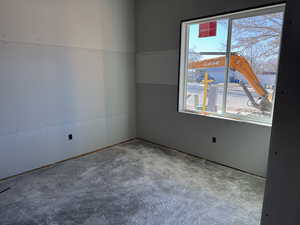 Empty room with a wealth of natural light and concrete floors