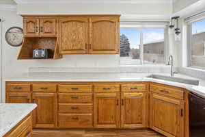 Kitchen with black dishwasher, decorative light fixtures, ornamental molding, and sink