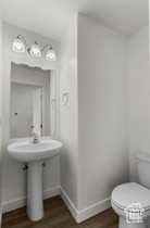 Bathroom featuring wood-type flooring and toilet