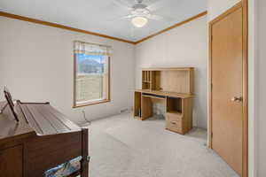 Carpeted office space with crown molding and ceiling fan