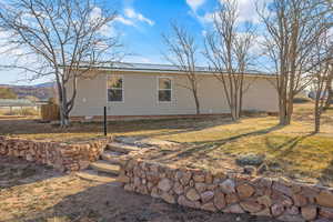 View of side of home featuring a yard