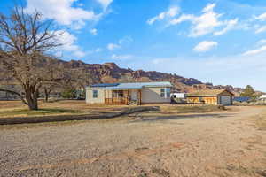 Single story home with a mountain view and solar panels