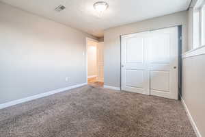 Unfurnished bedroom featuring a closet and carpet