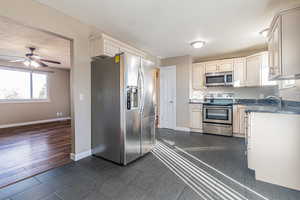 Kitchen featuring appliances with stainless steel finishes with view of front room