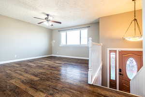 Foyer featuring a healthy amount of sunlight, ceiling fan, dark hardwood / wood-style floors, and a textured ceiling