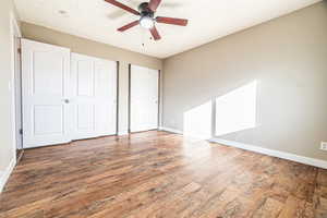 Unfurnished bedroom featuring ceiling fan and hardwood / wood-style floors