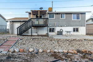 Rear view of property featuring cooling unit and a patio