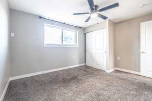 Unfurnished bedroom with carpet, a closet, and ceiling fan