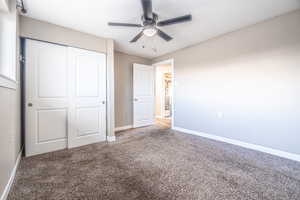 Unfurnished bedroom featuring carpet, a closet, and ceiling fan