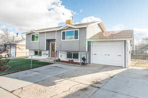 Front View of Home with a front yard and a garage