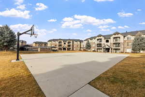 View of basketball court featuring a yard