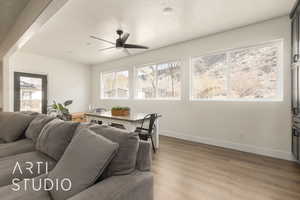 Dining space featuring ceiling fan, a textured ceiling, and hardwood / wood-style flooring