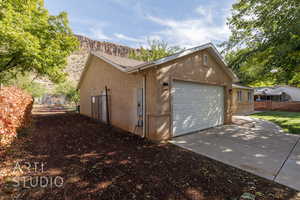 View of side of property featuring a mountain view and a garage