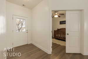 Foyer featuring ceiling fan and dark wood-type flooring