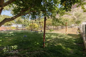 View of yard with a playground and a trampoline