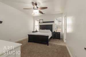 Carpeted bedroom with multiple windows and ceiling fan