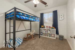 Carpeted bedroom featuring ceiling fan