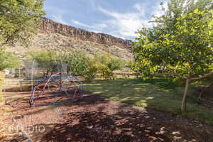 View of yard featuring a mountain view and a trampoline