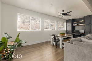 Living room featuring ceiling fan, a textured ceiling, and hardwood / wood-style flooring