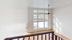 Stairs featuring ceiling fan, recessed lighting, wood finished floors, and baseboards