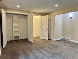 Bedroom 3 with carpet floors, a closet and a storage area