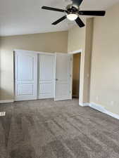 Owners Suite with ceiling fan. Unfurnished bedroom with carpet flooring, a closet, and lofted ceiling