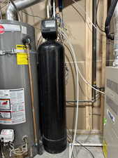 Utility room with gas water heater and water softener