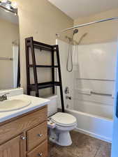 Owners Suite full bathroom with shower / washtub combination, vanity, and toilet