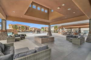 View of patio with pool water feature, a community pool, and an outdoor hangout area