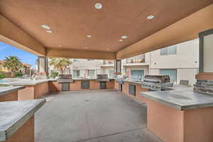 View of patio with grilling area, sink, and exterior kitchen