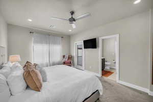 Bedroom featuring carpet flooring, ensuite bathroom, and ceiling fan