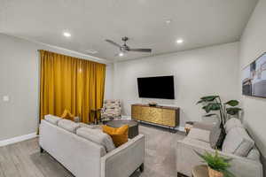 Living room featuring ceiling fan and light wood-type flooring