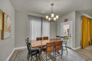 Dining area featuring a chandelier and light hardwood / wood-style flooring