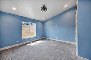 2nd bedroom on main floor with carpet flooring, recessed lighting, and lofted ceiling