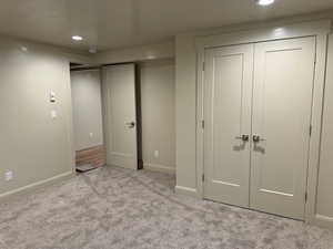 Unfurnished bedroom with light colored carpet