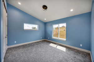 3rd main floor bedroom  carpet floors, vaulted ceiling, and recessed lighting