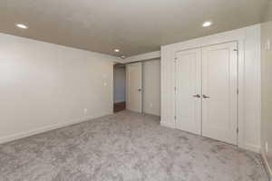 Bedroom 4 with a closet, carpet flooring, recessed lighting, and a textured ceiling