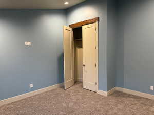 Unfurnished bedroom featuring carpet flooring