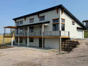 Back of property featuring a pergola and a patio area