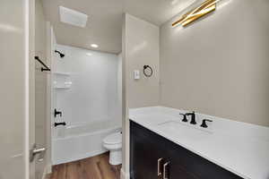2nd Full bathroom in basement featuring dark wood-type flooring, vanity, bathing tub / shower combination, and recessed lighting