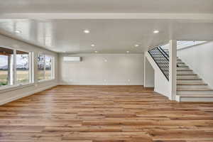 Stairway from main floor leading to daylight basement with recessed lighting