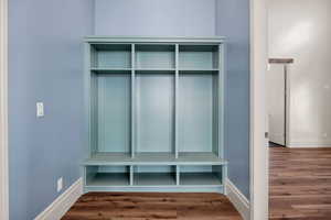 Mudroom with wood finished floors and baseboards