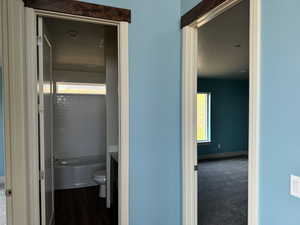 Hallway with carpet flooring and a textured ceiling