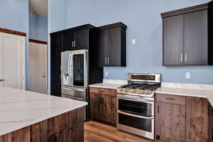 Kitchen featuring appliances with stainless steel finishes, a oven range with double ovens.